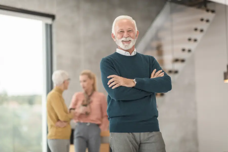 Confident man in his sixties standing in a bright living space, the kind of adult VapoCept is aimed at